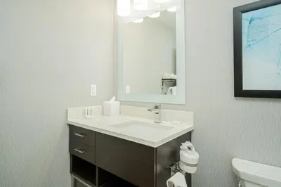 a bathroom with a sink and a mirror at TownePlace Suites by Marriott Brantford and Conference Centre in Brantford