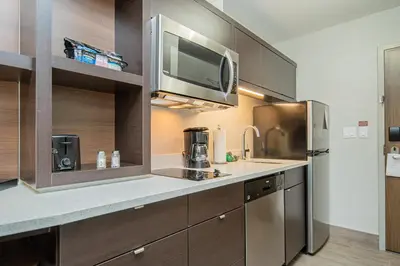 a kitchen with a sink and a microwave at TownePlace Suites by Marriott Brantford and Conference Centre in Brantford