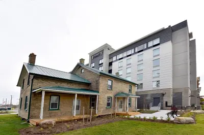 an old brick building next to a large building at Staybridge Suites - Waterloo - St. Jacobs Area in Waterloo
