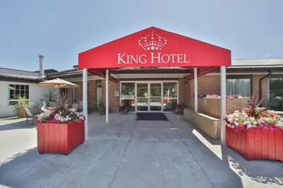 a king hotel with two large flower pots in front of it at King Hotel in Palmerston