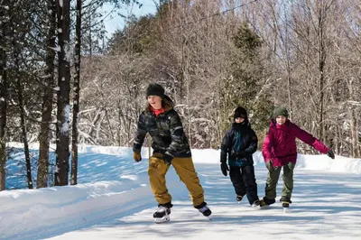 a group of three children playing in the snow at Blue Mountain Resort Inn in Blue Mountains