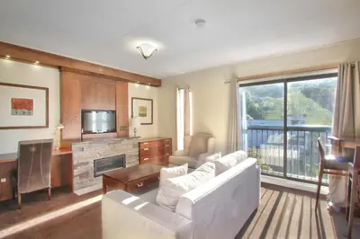 a living room with a couch and a fireplace at Blue Mountain Resort Inn in Blue Mountains