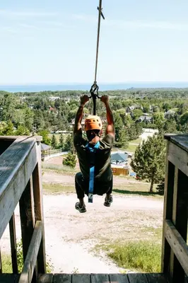 a man on a zip line in the air at Blue Mountain Resort Inn in Blue Mountains