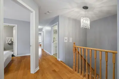 a room with a staircase and a chandelier at Amazing Spacious house in Center of Richmond hill in Richmond Hill