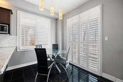 a dining room with a glass table and chairs at Amazing Spacious house in Center of Richmond hill in Richmond Hill