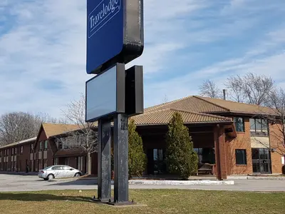 a street sign in front of a building at Travelodge by Wyndham Welland in Welland