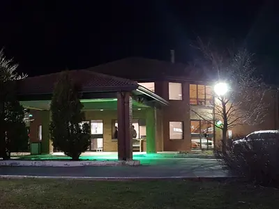 a building with green lights in front of it at night at Travelodge by Wyndham Welland in Welland