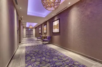a hallway with purple chairs and a rug at Hilton Garden Inn Toronto/Brampton West, Ontario, Canada in Brampton