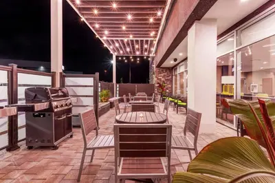 a patio with tables and chairs and a grill at Home2 Suites By Hilton Toronto/Brampton, On in Brampton