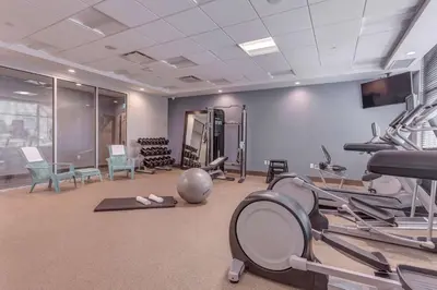a gym with treadmills and machines in a room at Home2 Suites By Hilton Toronto/Brampton, On in Brampton