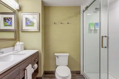 a bathroom with a toilet and a glass shower at Home2 Suites By Hilton Toronto/Brampton, On in Brampton