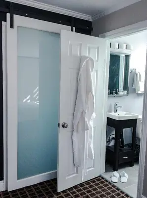 a bathroom with a white door and a sink at Walkerton Inn Motel in Walkerton