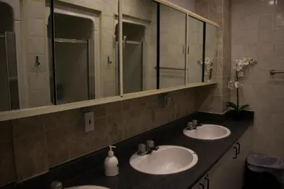 a bathroom with two sinks and a mirror at Saint Lawrence Residences and Suites in Toronto