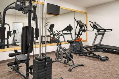 a gym with treadmills and elliptical machines at Howard Johnson by Wyndham Gravenhurst in Gravenhurst