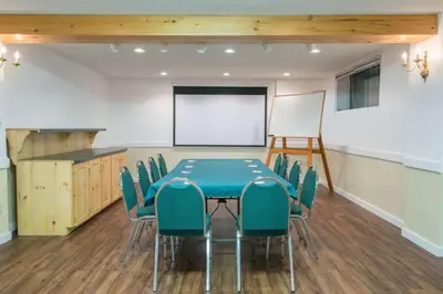 a conference room with a blue table and chairs at Howard Johnson by Wyndham Gravenhurst in Gravenhurst