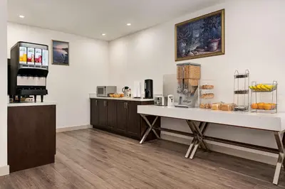 a kitchen with a counter and a table with food at Howard Johnson by Wyndham Gravenhurst in Gravenhurst