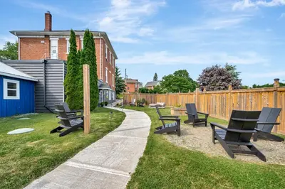 a group of benches sitting in the grass next to a fence at The Bloomfield Inn in Bloomfield