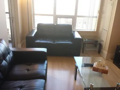 a living room with a leather couch and a coffee table at SPECTACULAR VIEW, 2 BEDROOMS FURNISHED CONDO and BEST LOCATION in Mississauga