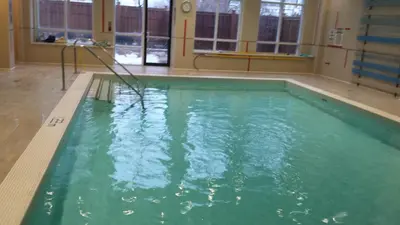 a pool with green water in a room with windows at SPECTACULAR VIEW, 2 BEDROOMS FURNISHED CONDO and BEST LOCATION in Mississauga