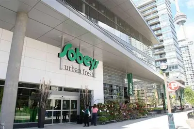 people standing outside of a shopping center at Cozy Condo near CN Tower in Toronto