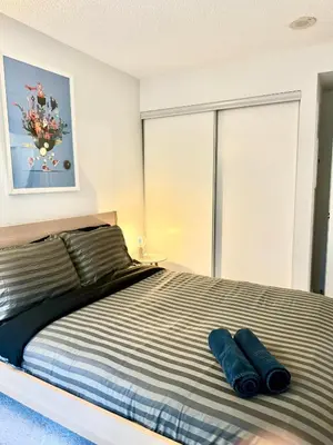 a bedroom with a bed with two pillows on it at Cozy Condo near CN Tower in Toronto
