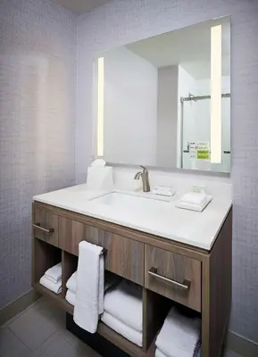 a bathroom with a sink and a mirror at Home2 Suites By Hilton Brantford in Brantford