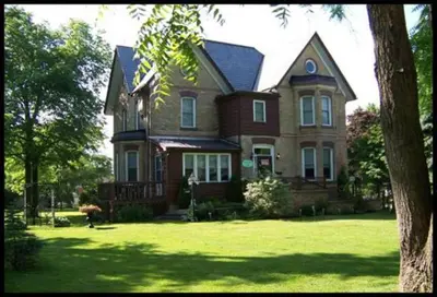 a large house with a large yard with green grass at Pemberley House Bed and Breakfast in Seaforth