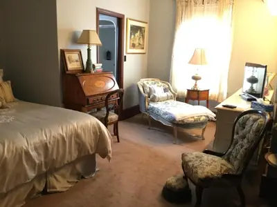 a bedroom with a bed and a chair and a desk at Pemberley House Bed and Breakfast in Seaforth
