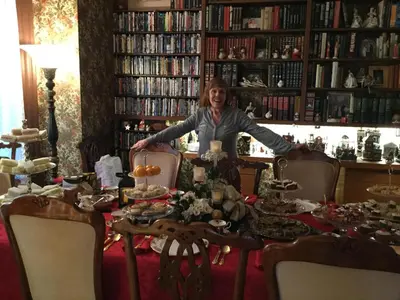 a woman sitting at a table in a library at Pemberley House Bed and Breakfast in Seaforth