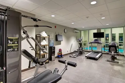 a gym with several treadmills and cardio machines at Best Western London Airport Inn & Suites in London