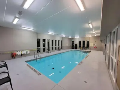 a large swimming pool in a building at Best Western London Airport Inn & Suites in London