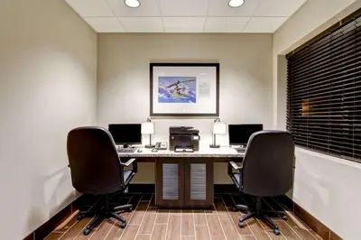 an office with a desk with two computers and two chairs at Best Western London Airport Inn & Suites in London