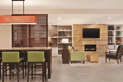a dining room with a table and a fireplace at Country Inn & Suites by Radisson, Belleville, ON in Belleville