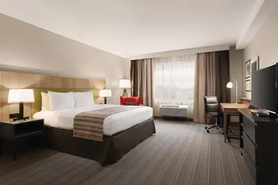 a hotel room with a bed and a desk at Country Inn & Suites by Radisson, Belleville, ON in Belleville