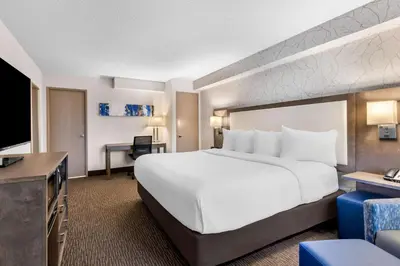 a hotel room with a large bed and a desk at Best Western Halton Hills in Georgetown