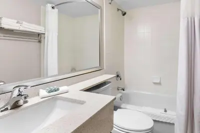 a bathroom with a sink and a toilet at Best Western Halton Hills in Georgetown