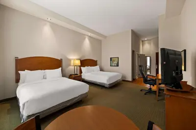 a hotel room with two beds and a flat screen tv at Best Western Plus Orangeville Inn & Suites in Orangeville