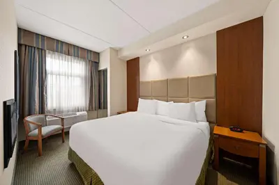 a large white bed in a hotel room at Best Western Plus Orangeville Inn & Suites in Orangeville