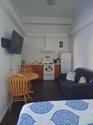 a living room with a couch a table and a kitchen at Campbellford Studio Apt 4 in Campbellford