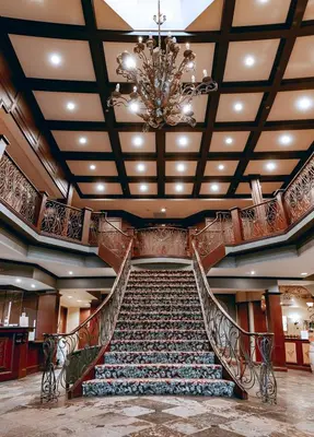 a staircase in a building with a chandelier at The Casablanca Hotel in Grimsby