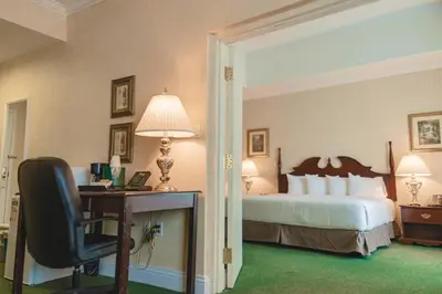 a hotel room with a bed and a desk with a chair at The Casablanca Hotel in Grimsby