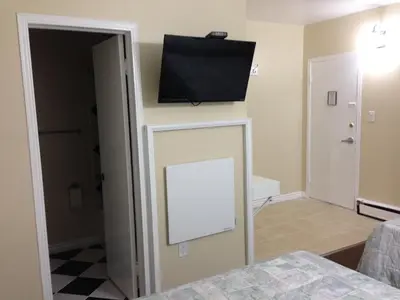 a room with a flat screen tv on a wall at Davidson Motel in Paris