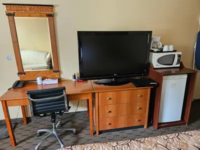 a desk with a television on top of it at Forest Plaza Motel in Mount Forest