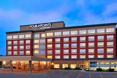 an office building with a sign on top of it at Four Points by Sheraton Cambridge Kitchener, Ontario in Cambridge