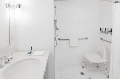 a white bathroom with a sink and a shower at Four Points by Sheraton Cambridge Kitchener, Ontario in Cambridge