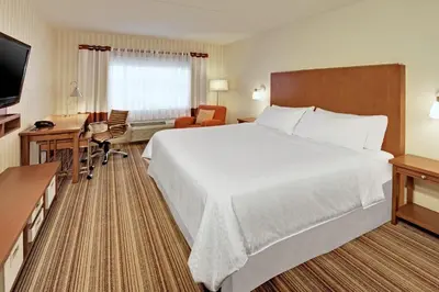 a hotel room with a large bed and a desk at Four Points by Sheraton Cambridge Kitchener, Ontario in Cambridge