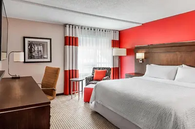a hotel room with a bed and a desk and chair at Four Points by Sheraton London in London