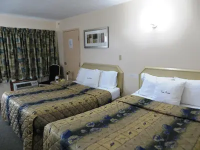 a hotel room with two beds and a window at Good Night Inn in Port Colborne