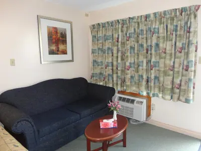 a living room with a couch and a table at Good Night Inn in Port Colborne