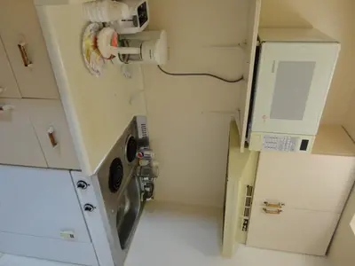 a small kitchen with a sink and a washing machine at Good Night Inn in Port Colborne